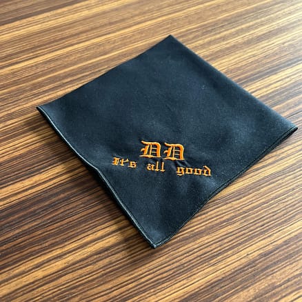 black handkerchief with orange embroidery